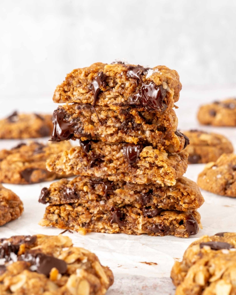 A stack of chunky, chewy oatmeal chocolate chip cookies, with melted chocolate chips