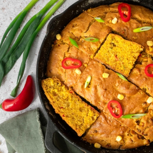 Golden Indian spiced cornbread in a cast iron pan