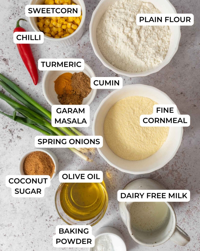 The ingredients needed to make an Indian cornbread recipe with sweetcorn, spring onion, spices and chilli.