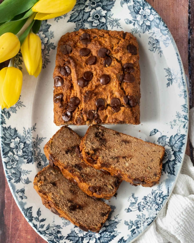A chocolate chip buckwheat banana bread on a pretty floral plate