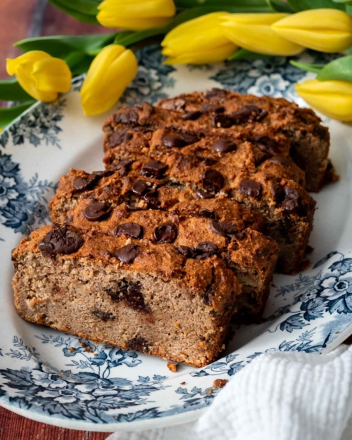 Slices of golden buckwheat banana bread on a vintage plate