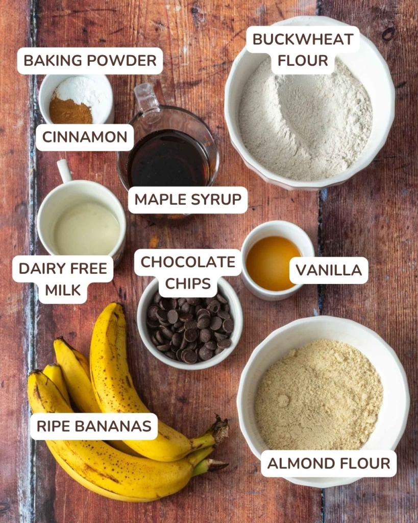 The ingredients needed to make buckwheat banana bread laid out on a wooden table
