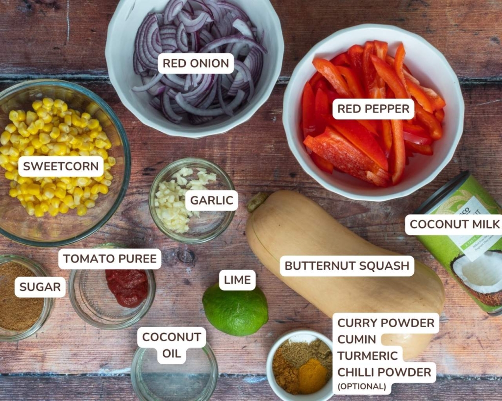 The ingredients needed to make sweet corn curry laid out on a wooden table top